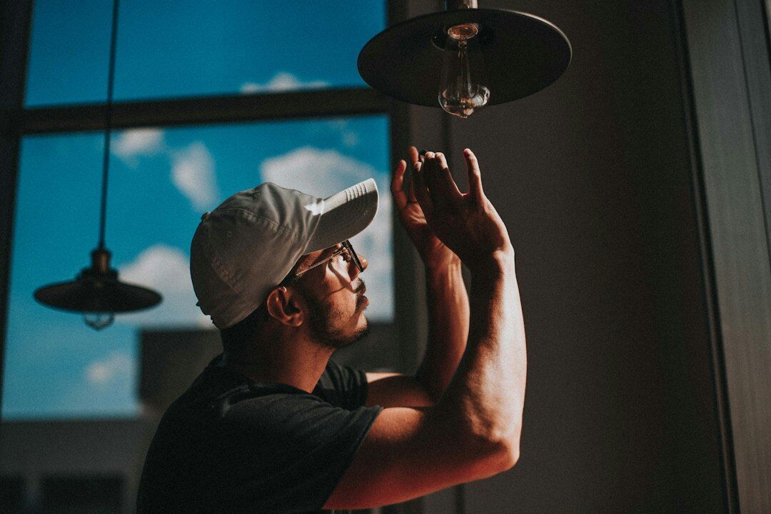 Portrait of a lighting technician holding a light fixture