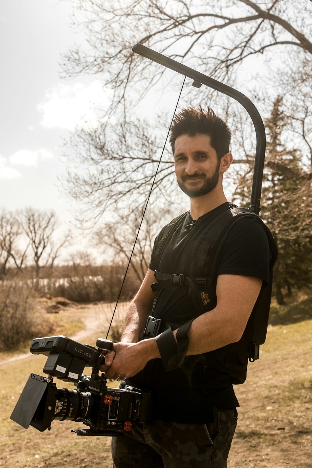 Boom operator holding a microphone boom pole on set